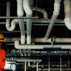 student looking at pipes