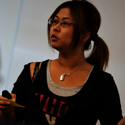 a female teacher teaching at the front of a classroom