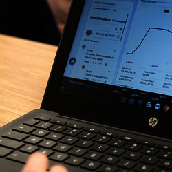 a student at a laptop looking at the stock market