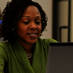 a woman looking at her laptop