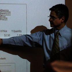 professor teaching in front of whiteboard