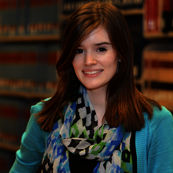 student in front of law books