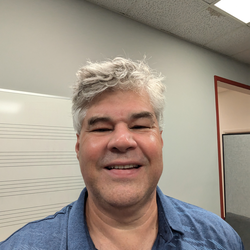 Michael Hull in blue shirt smiling