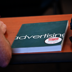 an advertising textbook on a student's desk