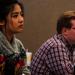 Students in a classroom attentively taking notes.