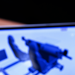 Person viewing 3D model on laptop screen.