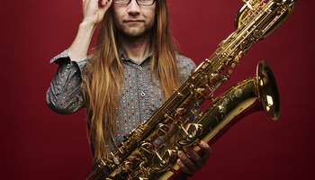 Photograph of a man holding the saxophone