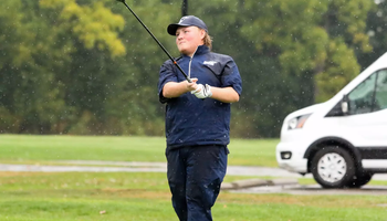 Peyton Woods golfing in the rain in UIS gear