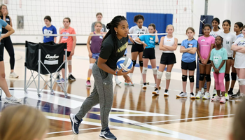 Kamille Jones coaches young athletes at volleyball camp