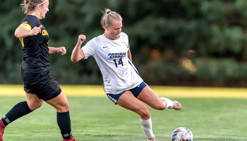 Addi Wittenberg playing soccer in white UIS uniform