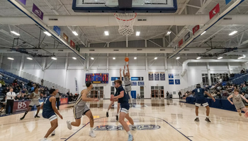 Adidas Davis attempting three-point shot on UIS basketball court