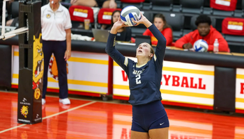 Madi Siefken playing volleyball in blue UIS uniform