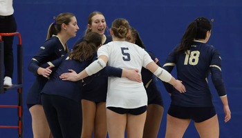 Volleyball Team huddle after a point