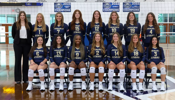 2025 UIS Volleyball Official Team Photo, athletes in navy blue uniform, also featuring Coach Ulrich