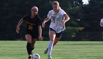Kalli Drexler playing soccer in white UIS uniform