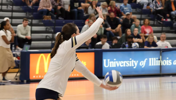 Makenna Cox serving in volleyball