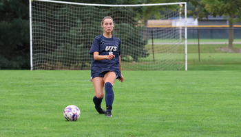 Megan Little playing the ball forward