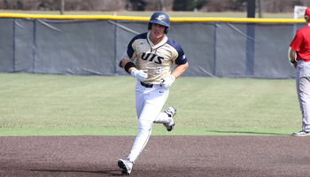 Kaden Griffitts running the bases in gold UIS uniform