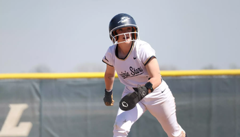 Rebecca Neupauer running the bases in white UIS uniform