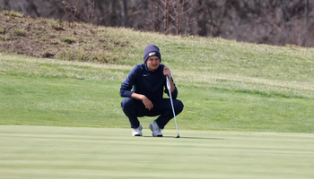 Sacha Lamraski preparing to make a putt in golf