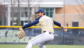 Derek Huber pitching in golf UIS uniform