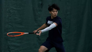Lin En Tan playing tennis in UIS uniform