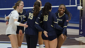 Volleyball team celebrating a point