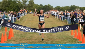 Madelyn Miller-Ross crosses finish line at cross country meet