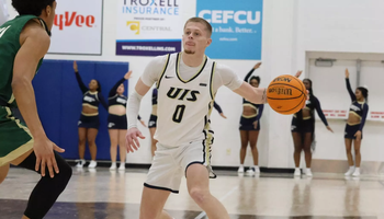 Brit Dutton playing basketball at UIS