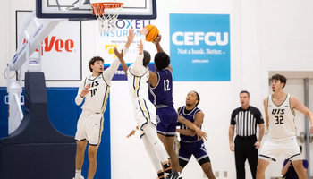 Isaiah Davis goes up for a block in men's basketball