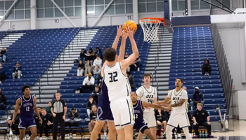Alex Stell playing basketball at UIS
