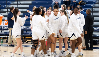 Women's basketball celebratory huddle