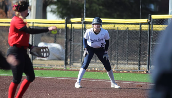 Calista Stahlhut on first base in white UIS uniform
