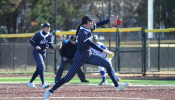 Rosie Bartletti pitching in blue pinstripe UIS softball uniform