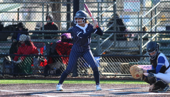 Sidney Sawyer playing softball in blue UIS uniform