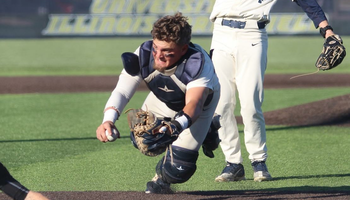 Ivan Dahlberg diving for the tag at home plate