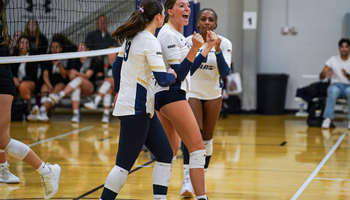 Carly Michels, Makenna Cox, and Erica Sledge celebrate scoring a point