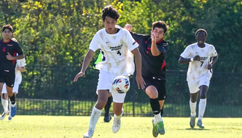 Rafael Pacino playing soccer in white UIS uniform