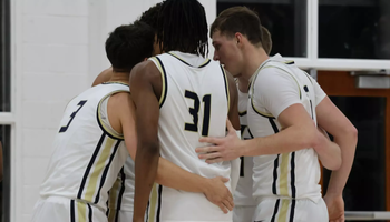 men's basketball team huddle