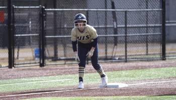 Rebecca Neupauer base running in gold UIS uniform