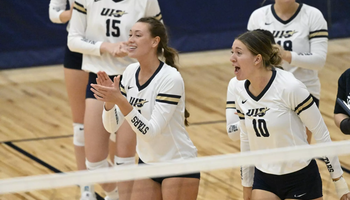 UIS bench celebrating at a volleyball  match