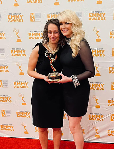 Yona Stamatis and Julie Staley holding the Emmy award.