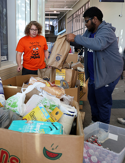 Students put collected food inside bins