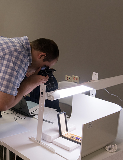 A student takes a photo of a historical artifact.