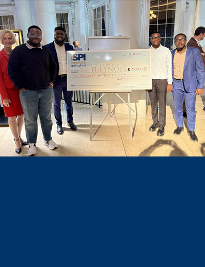 TredBase receives a large check during an event at the Abraham Lincoln Presidential Museum.