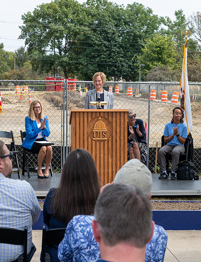 Chancellor Janet Gooch speaks at a podium during the UIS Library Commons groundbreaking ceremony.