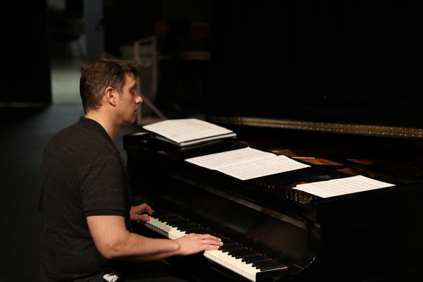 photo of a man playing a piano