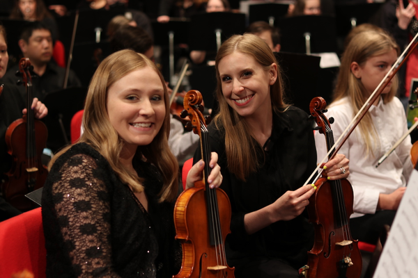 two women holding violins