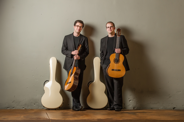 Two guys holding guitars for photoshoot