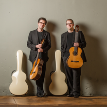 Two guys holding guitars for photoshoot